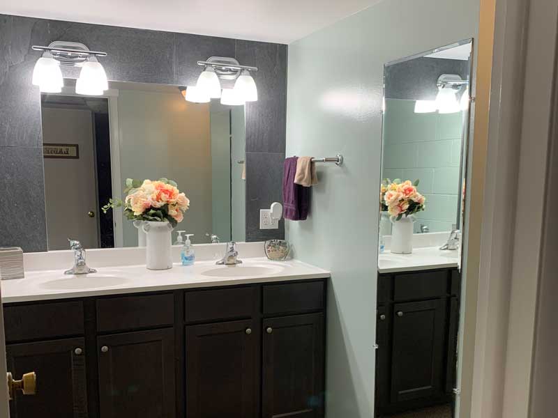 Powder room with double sink and separate toilet area