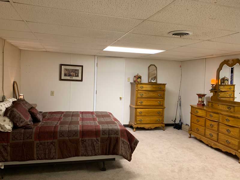 Large bedroom adjacent to shower and laundry facilities